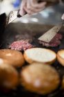 Beefburgers being fried — Stock Photo