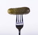 Pickled gherkin on fork — Stock Photo