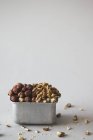 Hazelnuts and walnuts in container — Stock Photo