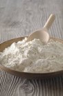 Flour in a wooden bowl — Stock Photo