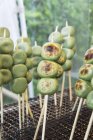 Closeup view of grilled green tea Dangos on skewers — Stock Photo