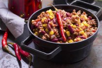 Chili con carne with chili peppers — Stock Photo