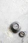 Closeup elevated view of weights on a floured marble surface — Stock Photo