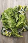 Fresh kale in colander — Stock Photo