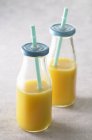 Orange juice in bottles — Stock Photo