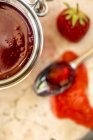 Strawberry jam in jar and on spoon — Stock Photo