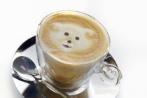 Cappuccino with a bear in the foam — Stock Photo