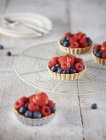 Berry tartlets on cooling rack — Stock Photo