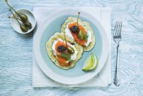 Courgette cakes with smoked salmon — Stock Photo