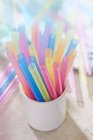 Closeup view of a mug of colorful straws — Stock Photo