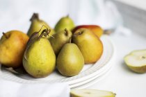 Autumn pears on white plate — Stock Photo