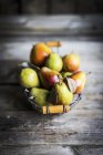 Autumn pears in wire basket — Stock Photo