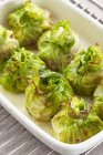 Stuffed, gratinated cabbage parcels  on white plate — Stock Photo