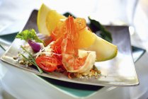 Салат из грейпфрута и креветок на тарелках — стоковое фото