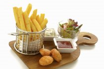 Chicken nuggets with chips and salad — Stock Photo