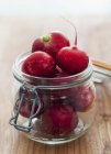 Fresh radishes in flip-top jar — Stock Photo