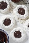 Meringue nests with chocolate sauce — Stock Photo