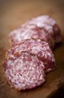 Slices of red wine salami — Stock Photo