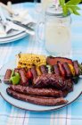 Grilled sausage skewer and sausages — Stock Photo