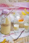 Elevated view of homemade Eggnog and a wire basket of fresh eggs — Stock Photo