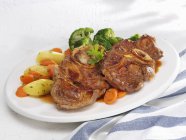 Ossobuco with carrots on plate — Stock Photo