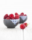 Bowls of fresh raspberries — Stock Photo