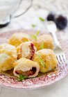 Damson dumplings with buttered crumbs on plate with fork — Stock Photo