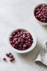 Frozen cranberries in bowls — Stock Photo