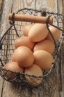 Eggs in wire basket — Stock Photo