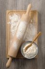 Farina in ciotola con mattarello — Foto stock