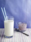 Glass of milk with two straws — Stock Photo