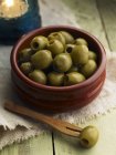 Pitted green olives in bowl — Stock Photo