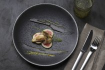 Top view of quail breast with figs and oil on plate — Stock Photo