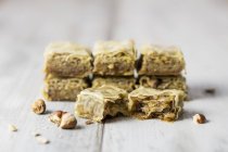 Closeup view of whole and broken baklava with hazelnuts — Stock Photo