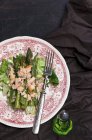 Asparagus salad with fish on plate — Stock Photo