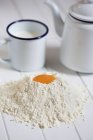 Egg yolks in heap of flour — Stock Photo