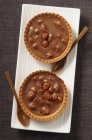 Chocolate tartlets with double-crunch nuts — Stock Photo