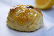 Hot cross bun with marmalade glaze — Stock Photo