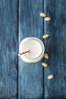 Almond milk in glass with straw — Stock Photo