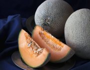Cantelope melons with wedges — Stock Photo