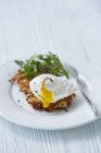 Potato fritter with poached egg — Stock Photo