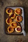 Top view of oven-roasted peaches with cinnamon — Stock Photo