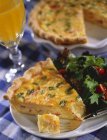 Quiche with salad on plates — Stock Photo
