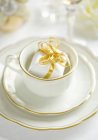 Closeup view of white crockery and a little present — Stock Photo