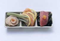 Closeup elevated view of Sashimi in a sectioned dish — Stock Photo