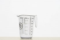 Closeup view of one measuring jug on white background — Stock Photo