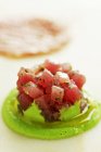 Tuna tartar with mushy peas over white background — Stock Photo