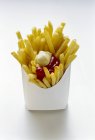 French fries with ketchup and mayonnaise — Stock Photo