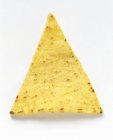 Un chip Tortilla en la superficie blanca - foto de stock