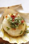Scallop with olive oil, garlic and parsleyon piece of paper — Stock Photo